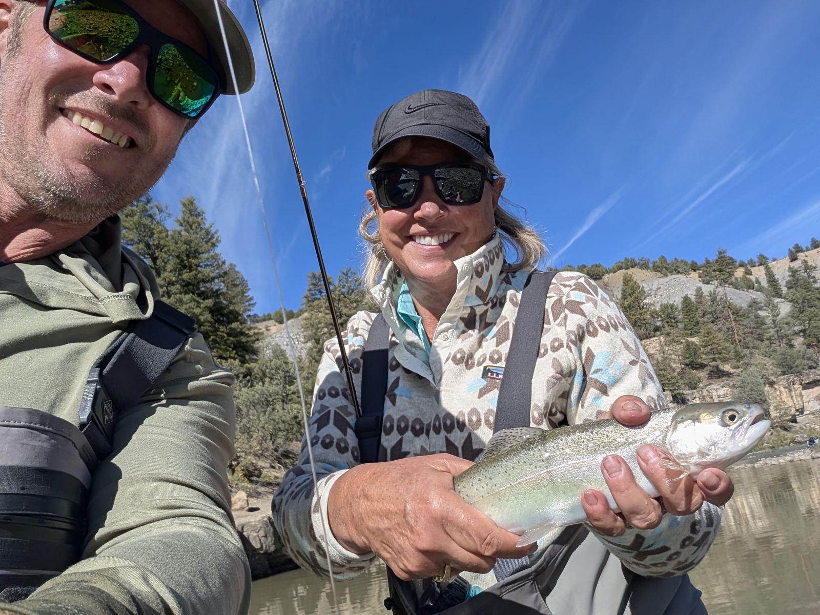 Your host and a guest on the river, holding a rainbow trout